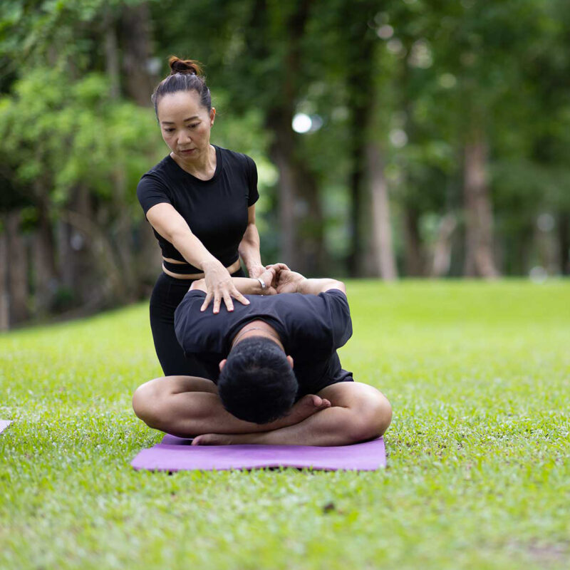 yoga instructor helping a student